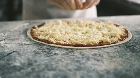 Close up for cook's hands putting cheese on the pizza Four Cheeses.Chef adding Stock Footage 199214677