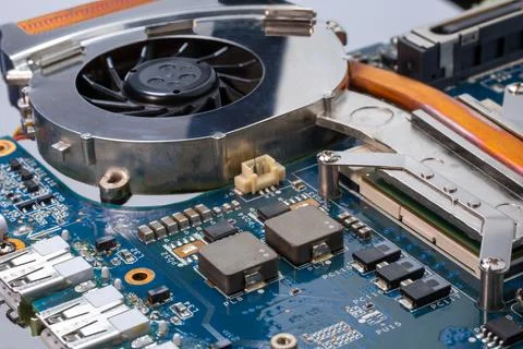 A close up of cooling fan for CPU computer motherboard PCB with chips on it 库存照片