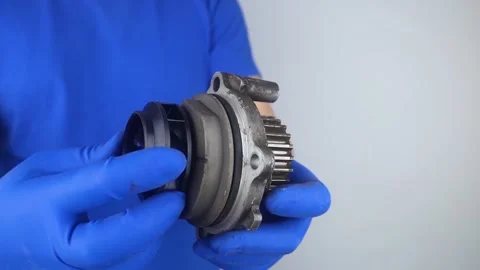 Close-up of the cooling system pump. Old car fluid pump. Replacement of spare pa Stock Footage 241559844