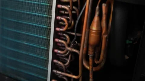 Close up of copper pipes and cooling coils inside an air conditioner or ref.. Stock Footage 338319420