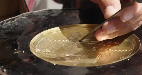 Close-up copper-smith engraves patterns on a metal plate. Traditional tinsmith Stock Footage 274301971