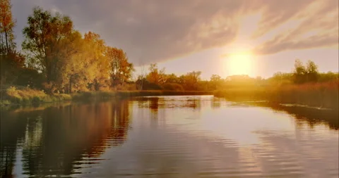 Close-up, the copter flies over the river, the sun's rays are reflected in the Stock Footage 164941432