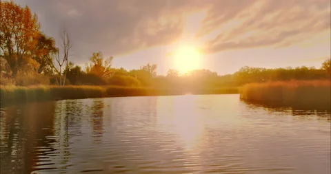 Close-up of a copter flying over the river, the sun is reflected in the water Stock Footage 164941944