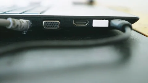Close-up . copy space. A human hand connecting LAN cords to a personal laptop Stock Footage 99529955