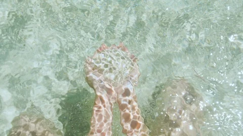 Close up of coral sand with pink bits in the hand of a girl. Rottnest Island Video stock 125263111