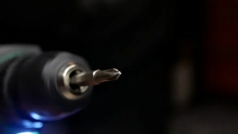 Close-up of cordless drill. Screwdriver attachment rotates at speed. Stock Footage 303114676