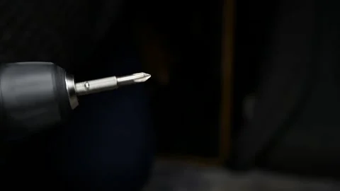Close-up of cordless drill. Screwdriver attachment rotates at speed. Stock Footage 303169497