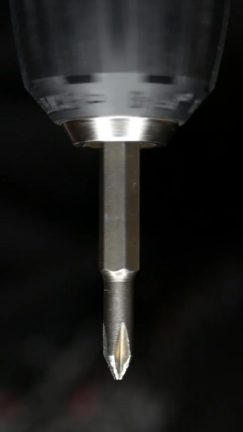 Close-up of cordless drill. Screwdriver attachment rotates at speed. Stock Footage 303690920