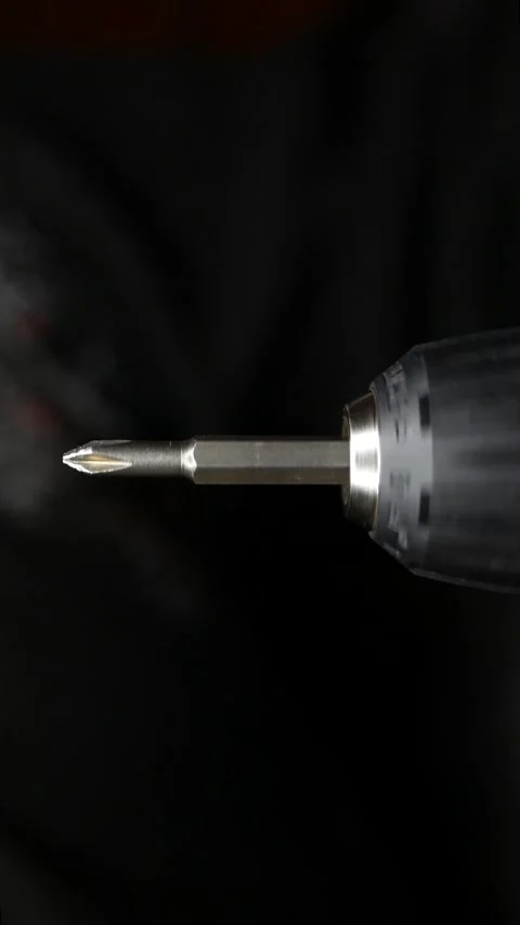 Close-up of cordless drill. Screwdriver attachment rotates at speed. Stock Footage 303768166