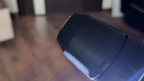 Close-up of a cordless power drill chuck spinning rapidly with a work light on Stock Footage 321700396