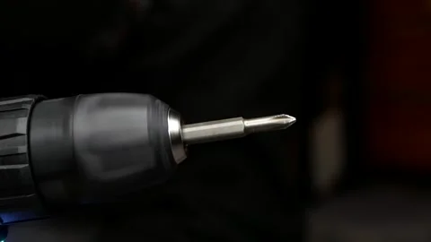 Close-up of cordless screwdriver. Screwdriver attachment rotates at speed. Stock Footage 303114674