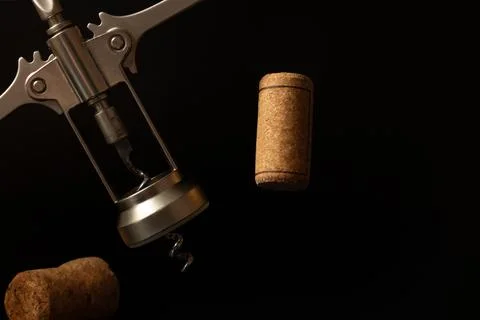 Close-up corkscrew and wine corks on the black background.	 Stock Photos