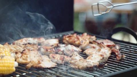 Close-up of corn and meat frying on a barbecue grill Stock Footage 268430885