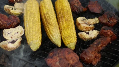 Close-up, corn and meat roasted on grill fire Stock Footage 91233303