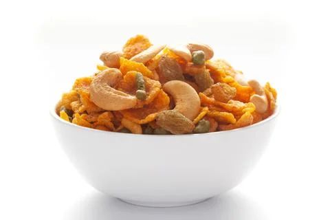 Close up of corn flex mixture Indian namkeen (snacks) on a ceramic white bowl Stock Photos
