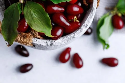 Close Up of Cornelian Cherries in Rustic Ceramic Bowl Stock Photos