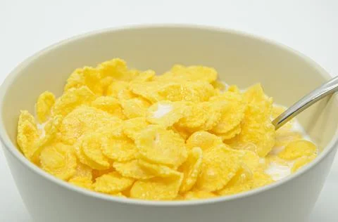 Close-up of cornflakes with milk-soaked in deep bowl with spoon Stock Photos