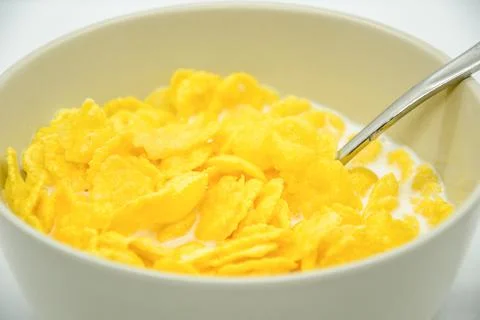 Close-up of cornflakes with milk-soaked in deep bowl with spoon Stock Photos