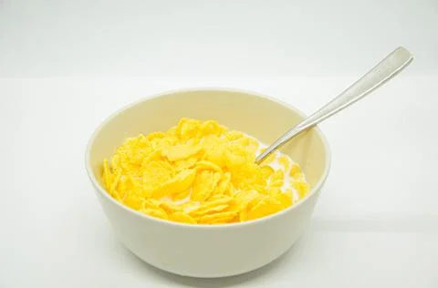Close-up of cornflakes with milk-soaked in deep bowl with spoon Stock Photos
