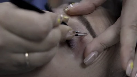 Close-up. Corrected eyebrows tweezers after staining with henna. Plucking eyebro Stock Footage 119227174