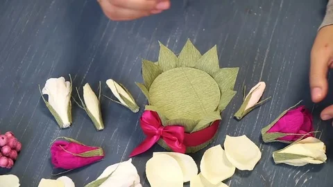 Close-up of corrugated paper hack bright pink in female hands. Female decorator Stock Footage 72631373