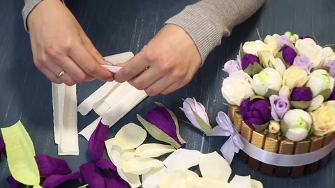 Close-up of corrugated paper hack bright pink in female hands. Female decorator Stock Footage 72682880