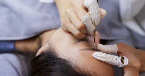 Close up of cosmetologist making microblading procedure Stock Footage 115478244
