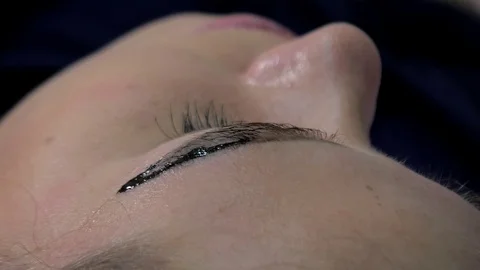Close-up of cosmetologist making microblading procedure. Permanent makeup Stock Footage 116035919