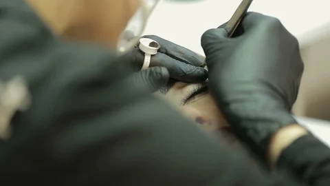 Close up of cosmetologist making permanent makeup.Microblading procedure. Video stock 87411227