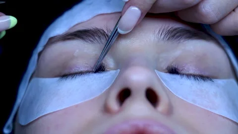 Close up cosmetologist puts lashes extentions on white woman, beauty procedure Stock Footage 150400997
