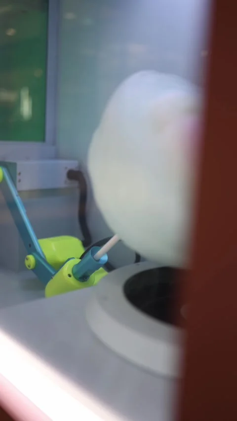 A close-up of a cotton candy machine in action, with fluffy white sugar threads  Stock Footage 292513986