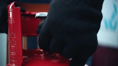 Close-up of a cotton gloved hand screwing the plug onto the cylinder thread Stock Footage 282671045