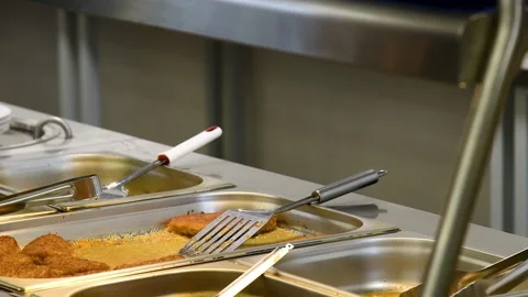 Close-up of a counter in a public dining room with stainless steel trays an.. Stockbeeldmateriaal 339765021