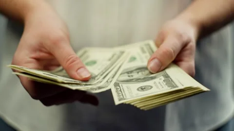 Close-up of counting dollars in female hands. Stock Footage 263245391