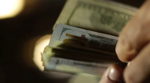 Close-up of a Counting Hundred  Dollar Bills Stock Footage 62655798