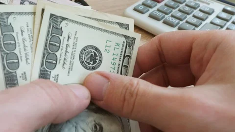 Close up of counting money. Dollar banknotes on a table. Stock Footage 86425828