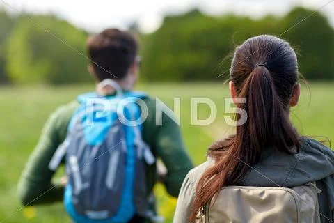 Close up of couple with backpacks hiking outdoors Stock Photos