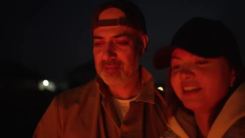 Close-Up of a Couple by a Campfire at Night Stock Footage 306733069