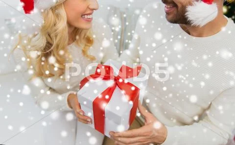 Close up of couple with christmas gift at home Stock Photos
