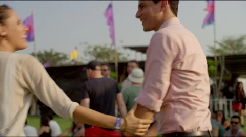 Close up of couple dancing and talking 
at a concert at sunset. Stock Footage 63077831