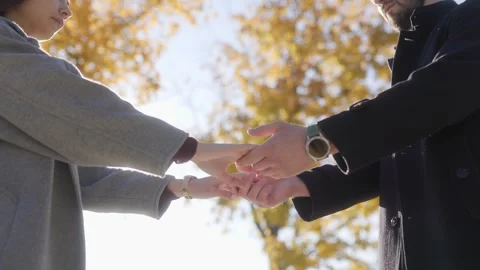 Close-up of couple hands coming together, showing love and unity Stock Footage 293593345