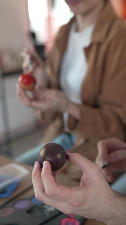 Close up on couple hands hands paint decorative easter egg in living room Stock Footage 301917324