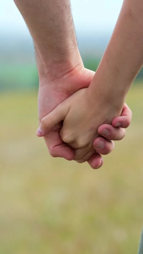 Close up of a couple holding hands and caressing each others fingers, showing Stock Footage 341440743