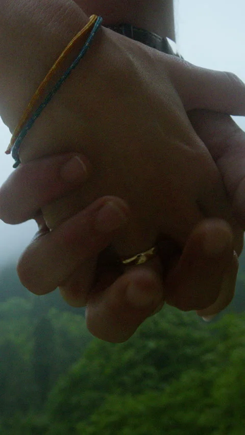 Close-up of couple holding hands during outdoor hike, symbolizing love, con.. Stock Footage 314612190