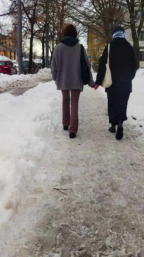 Close-up of a couple holding hands in a park against the background of winter. Stock Footage 263908107