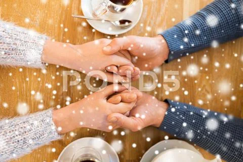 Close up of couple holding hands at restaurant Stock Photos
