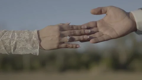 Close-up of couple holding hands with wedding rings Stock Footage 328256072