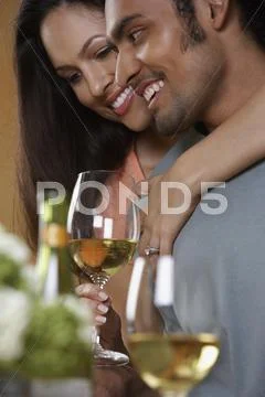 Close Up Of Couple Hugging And Drinking Wine