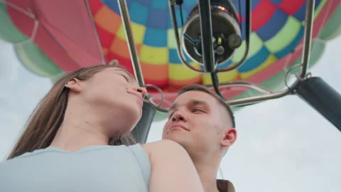 Close up couple inside balloon wicker basket beneath vibrant canopy Stock Footage 317149969