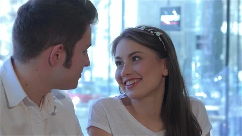 Close up of a couple sharing a joyful conversation at a cozy cafe Stock Footage 311673585